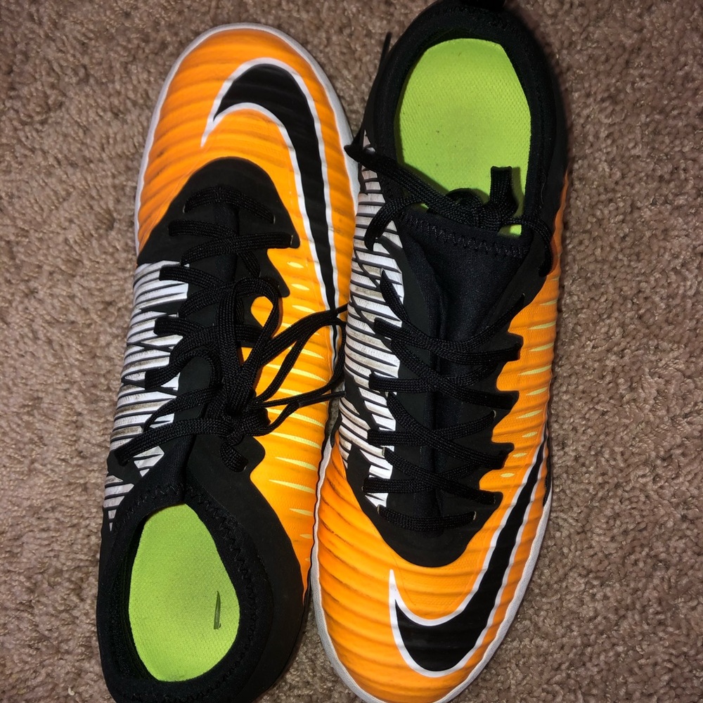 Orange and black NIKE woman’s futsal shoes